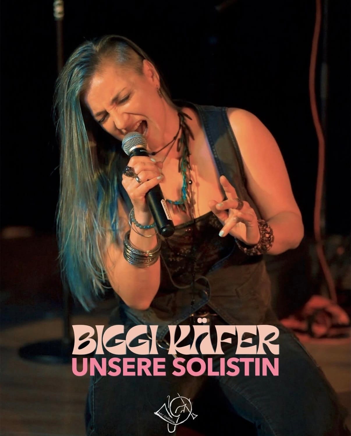Biggi Käfer kniet singend auf der Bühne, angekündigt als Solistin des Musikvereins Oedheim